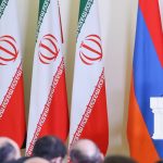Iranian President and Armenian PM in front of Iranian and Armenian flags