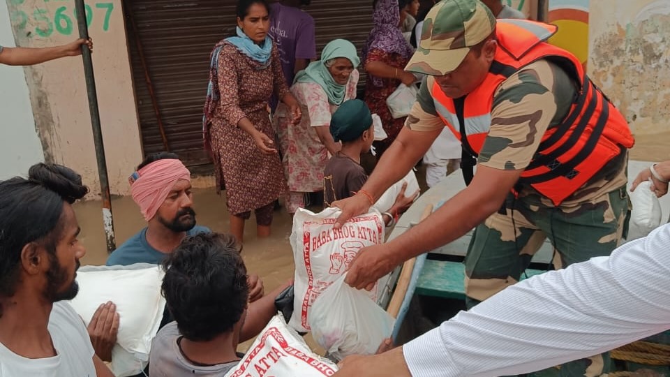 aid workers give food to victims of floods