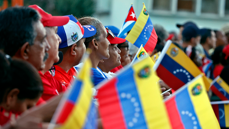 People hold up Cuban and Venezuelan national flags during a rally in support of Venezuela, in Havana, Cuba, October 17, 2025.