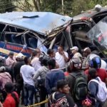 People gather next to an exploded bus on the Pan-American Highway in Colombia