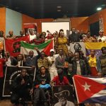 Kenyan socialists and leftists raise international revolutionary flags during a forum for African Liberation Day
